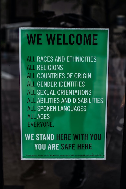 Poster that says We welcome all races and ethnicities, all religions, all countries of origin, all gender identities, all sexual orientations, all abilities and disabilities, all spoken languages, all ages. Everyone. We stand here with you. You are safe here.