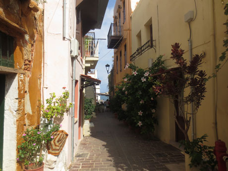 A narrow city street with flowers in Chania